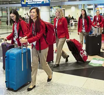 ?? — Bernama ?? Eager for action: Singapore netball team walking out of the Kuala Lumpur Internatio­nal Airport arrival gate on Saturday.