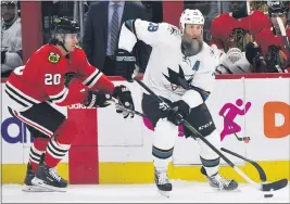  ?? PAUL BEATY — THE ASSOCIATED PRESS FILE ?? The San Jose Sharks’ Joe Thornton (19) moves the puck as the Chicago Blackhawks’ Brandon Saad (20) defends during the first period March 11in Chicago.