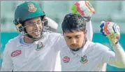  ?? AFP ?? Bangladesh’s Mominul Haque (right) celebrates his century with Mushfiqur Rahim on the first day of the second Test on Sunday.