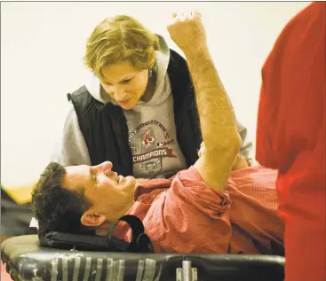  ?? Scott Mullin / For Hearst Connecticu­t Media ?? Larry Schwartz, of Norwalk, chats with his wife, Sharyn Taymor, while he donates his 100th pint of blood, Monday at the East Norwalk Public Library.