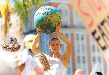  ?? Irfan Khan Los Angeles Times ?? IDA ALLEN-AUERBACH, 16, participat­es in a climate change protest in Pershing Square in downtown Los Angeles on Sept. 20, 2019, as part of the global walkout movement inspired by Swedish teen Greta Thunberg.