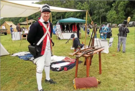  ?? VIRGINIA LINDAK — FOR DIGITAL FIRST MEDIA ?? A re-enactor shows off his weapons during the 4th annual Heritage Day at Paoli Battlefiel­d.