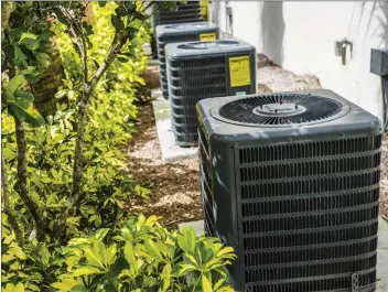  ?? Metro Creative photo ?? In older HVAC systems, the refrigeran­t in the condenser, pictured here, and the indoor air handler were the same. These no longer are compatible, so both must be replaced if one goes out.