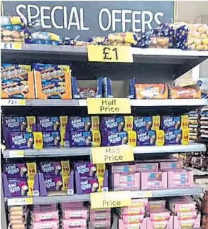  ??  ?? It's a bargain...cut-price cakes and biscuits on display in the store yesterday