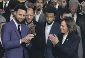 ?? Susan Walsh Associated Press ?? STEPHEN CURRY, left, and the champion Warriors celebrate with Vice President Kamala Harris.