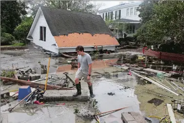  ?? GRAY WHITLEY/SUN JOURNAL VIA AP ?? Resident Joseph Eudi looks at flood debris and storm damage from Hurricane Florence at a home on East Front Street in New Bern, N.C., on Saturday.