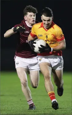  ??  ?? Sarsfields midfielder Dylan Furlong is chased by Jack Devereux.