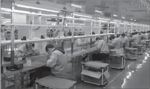  ??  ?? LONDON
Industry workers working on their seats.
-REUTERS