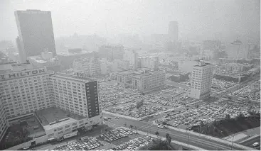  ?? Associated Press file photo ?? Parking lots in downtown Los Angeles fill up in 1979. In a study on lead exposure, researcher­s examined only that caused by leaded gasoline, the dominant form of exposure from the 1940s to the late 1980s.