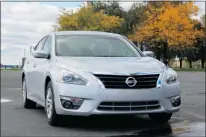  ?? PHOTOS: KEVIN MIO, THE GAZETTE ?? The 2013 Nissan Altima has a sleeker silhouette, thanks to a longer sloping rear roofline and a raised trunk. Its wide stance and aggressive front-end styling — with its grille design, seamless bumper and projector-type headlights — catches the eye...