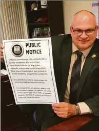  ?? Mark Zaretsky / Hearst Connecticu­t Media ?? New Haven Assistant Police Chief Karl Jacobson on May 5 with a public notice the Police Department has been posting to inform people that ATVs are not allowed to operate on city streets.