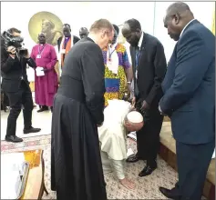  ??  ?? Photo taken and released by the Vatican Press Office, Vatican Media, shows Pope Francis (bottom) kneeling to kiss the feet of Kiir (centre) and Machar (right) at the Pope’s Santa Marta residence in the Vatican. Pope Francis knelt and kissed the feet of leaders of South Sudan at the end of a two-day retreat to help them solidify a peace agreement. — AFP photo