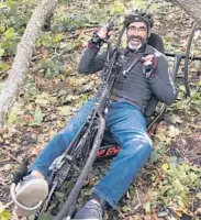  ?? NEIL STANTON ?? Todd Balf pedals beneath a storm-tossed tree on a cycling route.