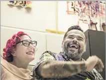  ??  ?? TANYA MUELLER, left, and chef-husband Avila host a meal at their Glendale loft for a seasonal gathering of longtime friends.