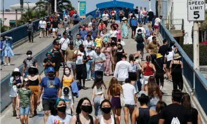  ?? Photograph: Caroline Brehman/EPA ?? People walk in Santa Monica, California. The Census Bureau results showed that US metro areas accounted for almost all the country’s population growth.