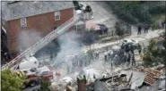  ?? MARY ALTAFFER—THE ASSOCIATED PRESS ?? In this Sept. 27, 2016 file photo, emergency service personnel work at the scene of a house explosion in the Bronx, where firefighte­r Michael Fahy, a 17-year fire department veteran, was killed after responding to a report of a gas leak at the home.