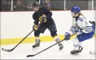  ?? Dave Stewart / Hearst Connecticu­t Media ?? Simsbury’s Mackenzie Chapman (3) passes the puck from behind the net while Darien’s Lucie Edwards (15) defends during a girls ice hockey game at the Darien Ice House on Jan. 28.