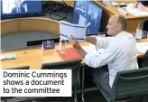  ??  ?? Dominic Cummings shows a document to the committee