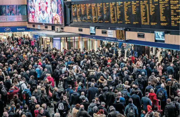  ?? JACK BOSKETT/ RAIL. ?? Passengers scan informatio­n boards at London Euston during disruption caused by Storm Doris on February 23. Ian Taylor says that when journeys don’t go according to plan, passengers feel abandoned and let down.