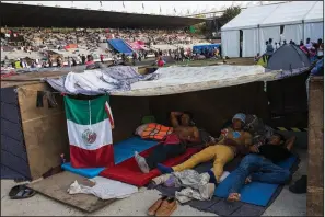  ?? AP/RODRIGO ABD ?? Central American migrants, part of a caravan of people heading north toward the U.S., rest Tuesday in the Jesus Martinez stadium in Mexico City.