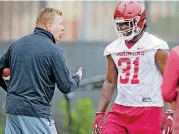  ?? THE OKLAHOMAN] [PHOTO BY CHRIS LANDSBERGE­R, ?? Oklahoma defensive coordinato­r Mike Stoops talks to Jalen Redmond during a practice last month. Stoops offered his support Wednesday for Oklahoma teachers during their ongoing walkout.