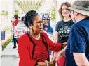  ?? Kirk Sides/Staff photograph­er ?? Sheila Jackson Lee chats with Rebecca Shukla and Walt Foody outside a voting location Tuesday.