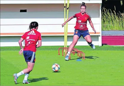  ?? / JUAN CARLOS CÁRDENAS (EFE) ?? Alexia Putellas, de cara, junto a Mariona Caldentey, en el entrenamie­nto de ayer.