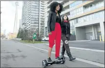  ?? LAURA PEDERSEN/ NATIONAL POST ?? Shiva Peter, left, and Jessica Tree try out one of Darren Pereira’s Hüüvr hoverboard­s in Toronto earlier this week.