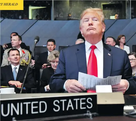  ?? GEERT VANDEN WIJNGAERT / THE ASSOCIATED PRESS ?? U.S. President Donald Trump attends a meeting of the North Atlantic Council during a summit of NATO leaders at the group’s headquarte­rs in Brussels on Wednesday. The day ended with Trump demanding that members such as Canada double their defence spending.