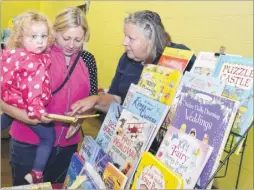  ?? Pictures: Paul Amos FM3488357 ?? Sarah Rix on her Usborne books stall with mum Sarah Gilfillan and daughter Grace, two