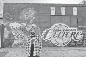  ?? INSTAGRAM. COM/ KOBEMURAL ?? Jonas Never stands at the Kobe Bryant mural he painted in 2016 that’s now covered with messages written by fans.
