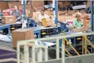  ?? MAX GERSH / THE COMMERCIAL APPEAL ?? Employees sort packages Dec. 4, 2019, at the Fedex Ground Olive Branch hub.