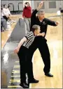  ?? MARK HUMPHREY ENTERPRISE-LEADER ?? A referee holds Prairie Grove girls basketball coach Kevin Froud in check during Friday’s game against Elkins. Froud was forced to use timeouts to get his star player, Trinity Dobbs, breaks to work out cramps during the fourth quarter. Dobbs gritted it out scoring 22 points to propel the Lady Tigers to a 38-32 win.