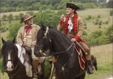  ?? LAURIE SPARHAM — DISNEY VIA AP ?? This image released by Disney shows Josh Gad as Le Fou, left, and Luke Evans as Gaston in a scene from, “Beauty and the Beast,” opening nationwide on March 17.