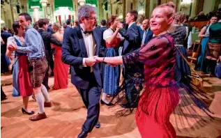  ??  ?? ' Taxi dancer' Edgar Kogler, 49, dances with a partner during a dance ball at Hofburg palace ( left) and Roman Svabek, profession­al dancer and ceremony master of the Vienna Opera ball, poses for a picture at his dance school ( right), in Vienna