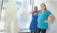  ?? SCOTT GARDNER THE HAMILTON SPECTATOR ?? Nicola Topsom and her daughter, Divna, 10, stand with a recent donation of wedding dresses for the Floriana Project.