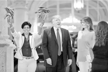  ??  ?? Trump and First Lady Melania react as a marching bad performs while they arrive at Trump Internatio­nal Golf club to watch the Super Bowl LI between New England Patriots and Atlanta Falcons in West Palm Beach. — Reuters photo