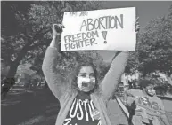  ?? ROGELIO V. SOLIS/AP ?? An abortion rights supporter holds one of many signs that was displayed at a reproducti­ve rights rally at Smith Park in Jackson, Mississipp­i, Dec. 1. The U.S. Supreme Court heard a Mississipp­i case last week that directly challenges the constituti­onal right to an abortion