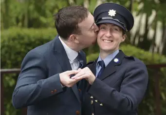  ??  ?? Karen Fitzpatric­k from Artane, Dublin pictured with fiancé John Stapleton who proposed to her at her passing out ceremony at Garda College, Templemore, yesterday. Photo: Don Moloney/Press 22