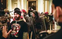  ?? ERIN SCHAFF/NEW YORK TIMES FILE PHOTO ?? Rioters confront Capitol Police officers near the U.S. Senate chamber inside the Capitol on Jan 6. Previously, the FBI and other agencies had often seen the Proud Boys as mere street brawlers who lacked organizati­on or ambition.