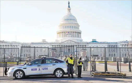  ?? John Minchillo The Associated Press ?? Fencing is placed around the exterior of the Capitol grounds Thursday morning. A violent throng spent hours Wednesday running rampant through the Capitol.