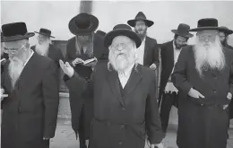  ??  ?? Ultra- Orthodox Jewish men pray during a protest against any plans to make them undergo military service in Jerusalem on Sunday. In 2013, the Israeli Cabinet agreed to end a practice under which tens of thousands of ultra- Orthodox men were exempted...