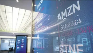  ?? (Photo: AFP) ?? Stock informatio­n about Amazon is displayed on a monitor inside Nasdaq’s new ‘Client Experience Center’ at their office in Times Square,thursday in New York City.