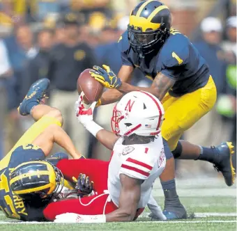  ?? Paul Sancya, The Associated Press ?? Michigan's Ambry Thomas recovers a fumble by Nebraska Tyjon Lindsey on a punt return after Jake McCurry made the tackle on Sept. 22, 2018. Thomas started only one season at Michigan in 2019 and opted out of the 2020 season.