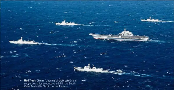  ??  ?? Red fleet: China’s ‘Liaoning’ aircraft carrier and supporting ships conducting a drill in the South China Sea in this file picture. — Reuters