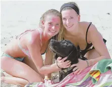  ?? STAFF PHOTO BY MATT WEST ?? ‘THEY’RE JUST HUNGRY’: Fear of sharks kept Ryan Speicher, at left with sister Laura, close to shore.