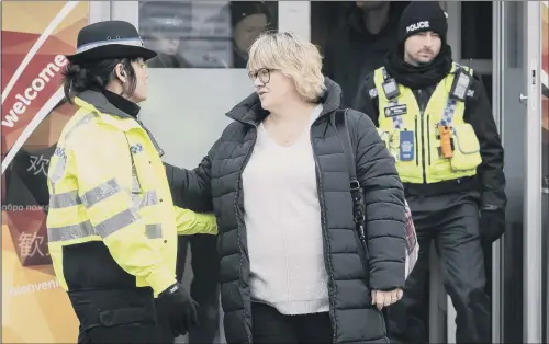  ?? PICTURE: PA. ?? LIVING IN HOPE: Lisa Squire, the mother of missing student Libby Squire, inset, speaks to a police officer on leaving a service at Hull Community Church yesterday.