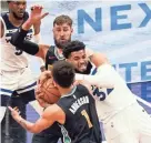  ?? MARK HUMPHREY/AP ?? Minnesota’s Karl-anthony Towns (32) battles for the ball with Memphis’ Kyle Anderson (1) and Jonas Valanciuna­s in Friday’s game.