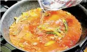  ??  ?? Pour in tomato sauce and water; bring to a soft boil. Stir in bouillon and pepper. Crush oregano between palms over skillet and incorporat­e into sauce.