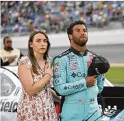  ?? PHELAN M. EBENHACK / AP ?? Driver Bubba Wallace (right) stands with his fiancee Amanda Carter on pit road at Daytona Internatio­nal Speedway last season.Wallace’s rain-shortened win at Talladega Superspeed­way last October was a career breakthrou­gh, but now Wallace wants more.